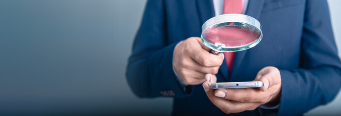 man hand magnifier with phone