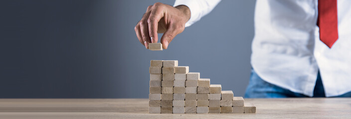 worker hand wooden cubes