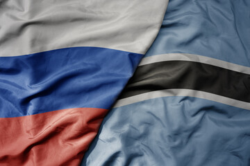 big waving realistic national colorful flag of russia and national flag of botswana .