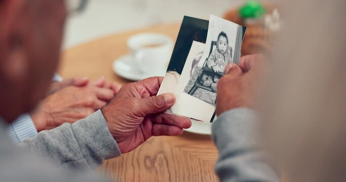 Hands, photograph and nostalgia with senior friends thinking about the past while in a nursing home. History, memory and retirement with an elderly group holding a picture closeup to remember life