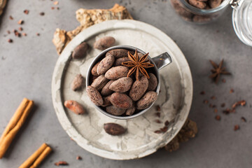 Cocoa beans on a dark grey background. Roasted cocoa beans.