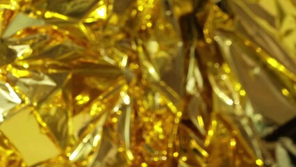 defocused crumpled gold foil, fashion texture background. High quality FullHD footage - Powered by Adobe