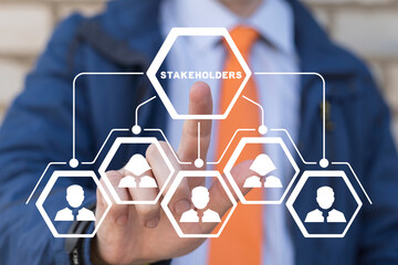 Businessman using virtual touchscreen presses word: STAKEHOLDERS. Concept of business finance...