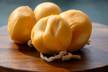 Italian semi hard handmade smoked scamorza cheese, from cow milk from Apulia or Calabria regions close up