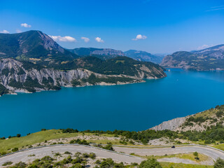 Aerial view on blue Lake of Serre-Poncon, reservoir border...