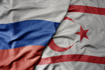 big waving realistic national colorful flag of russia and national flag of northern cyprus .