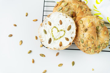 Sandwich, toast, Philadelphia cheese bagel, sunflower seeds and painted pesto heart.
