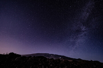 Fototapeta premium Stargazing at Mauna Loa Observatory Road, Big Island Hawaii. Starry night sky, Milky Way galaxy astrophotography. Mauna kea. Milky Way is our home galaxy, a barred spiral galaxy 