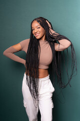 Beautiful young woman, standing, messing with her long hair.