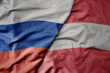 big waving realistic national colorful flag of russia and national flag of austria .