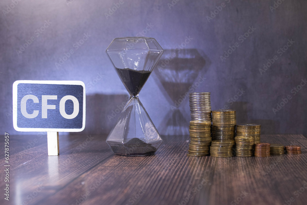 Poster text cfo on a wooden cube blocks on notepad background near pen
