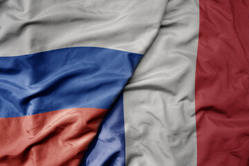 big waving realistic national colorful flag of russia and national flag of france .