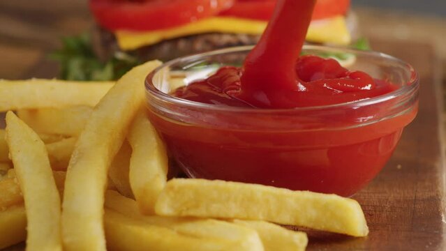 Dipping french fry into ketchup