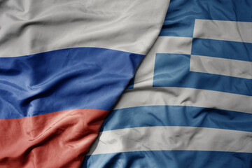 big waving realistic national colorful flag of russia and national flag of greece .