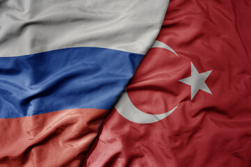 big waving realistic national colorful flag of russia and national flag of turkey .