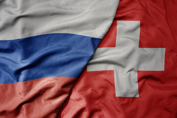 big waving realistic national colorful flag of russia and national flag of switzerland .