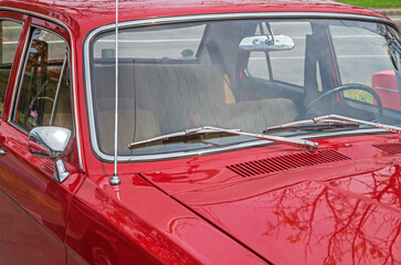 View on interior of retro car through windshield from the side of hood