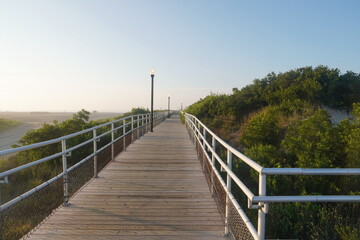Boardwalk with Historic Lighting and Railings Through Dunes in Summer