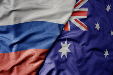 big waving realistic national colorful flag of russia and national flag of australia .