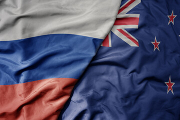 Fototapeta premium big waving realistic national colorful flag of russia and national flag of new zealand .