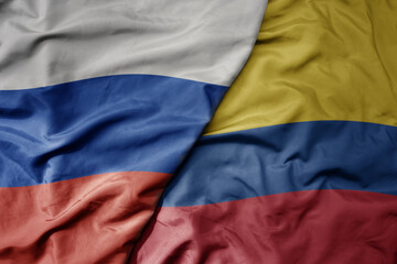 big waving realistic national colorful flag of russia and national flag of colombia .
