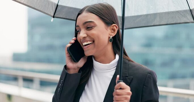 Phone call, communication and woman with umbrella in the city on rooftop of her office building. Technology, raining and professional female person on mobile conversation on a balcony in urban town.