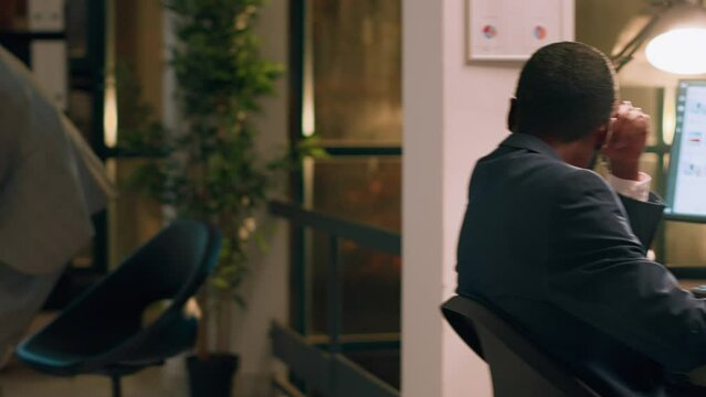 Pissed off computer operator fed up with loud colleague listening to music and pretending to beat drums at work. Businessman annoyed by bothersome coworker perturbing him in office