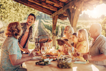 Multigenerational family having a family lunch outdoors on a patio