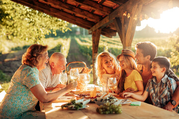 Multigenerational family having a family lunch outdoors on a patio