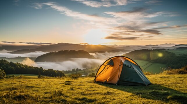A backpacker's camping tent at beautiful green grass field and mountains.