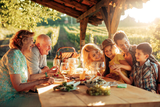 Multigenerational family having a family lunch outdoors on a patio