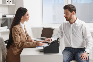 Human resources manager conducting job interview with applicant in office