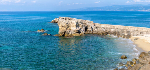 View of coastline in southern Italy. Scenic view from on top cliff looking out to sea. Calabria coastline with eroded cliff on beach
