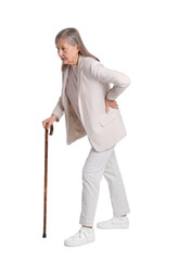 Senior woman with walking cane suffering from back pain on white background