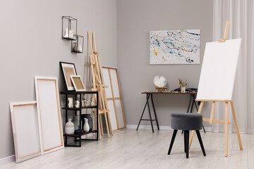 Artist's studio with easels, canvases and painting supplies