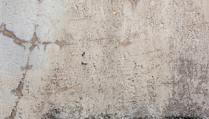 Wall fragment with scratches and cracks. Textured weathered surface for background.