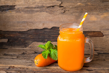 Carrot juice fruit smoothies yogurt drink yellow healthy delicious taste in a glass slush for weight loss on wooden background.
