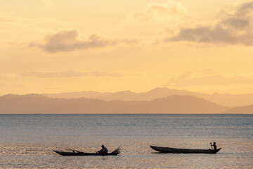 Fisherman in Pirogue at Nosy Boraha, also known as Sainte-Marie island, east coast of Madagascar. Sunset