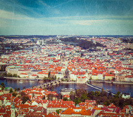 Fototapeta na wymiar Vintage retro hipster style travel image of aerial view of Charles Bridge over Vltava river and Old city from Petrin hill Observation Tower with grunge texture overlaid. Prague, Czech Republic