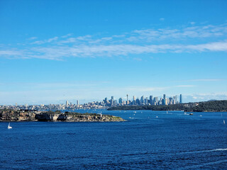 Obraz premium The City of Sydney Australia Viewed From North Head. Looking over Sydney Harbour filled with sailing boats