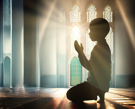 Muslim Islam kid child boy praying with mosque in background. Concept of Islam Islamic Ramadhan Ramadan Eid