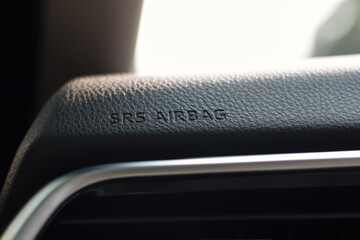 Sign of SRS Airbag, Supplemental Restraint System Airbag, on car dashboard. It helps to prevent...