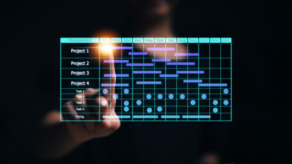 Project manager and updating tasks and milestones progress planning with Gantt chart scheduling interface for the company on virtual screen. Business Project Management System.