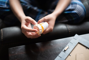hands opening a pill bottle