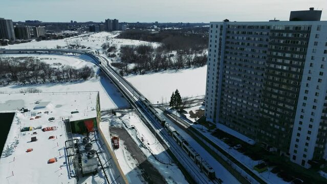 Drone shot train travelling through Ottawa city in Canada in winter snow