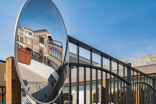 Round mirror for inspection.A viewing mirror in the parking lot. A spherical convex mirror on the street road
