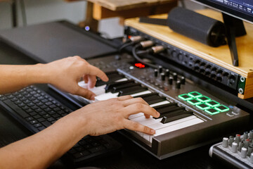 Fototapeta na wymiar hands on board playing piano roll. Music Production, Home Studio Recording