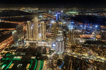 Fototapeta na wymiar Night view from the observation deck of the tallest building in the world - Burj Khalifa illuminated by lights the Dubai city, United Arab Emirates