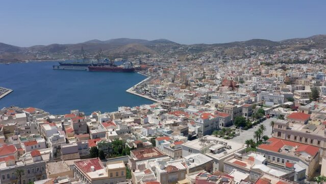 Slow panoramic drone shot of Syros island port during morning