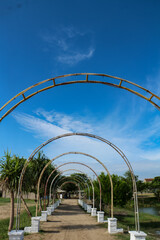 Outdoor archway with blue sky and white clouds